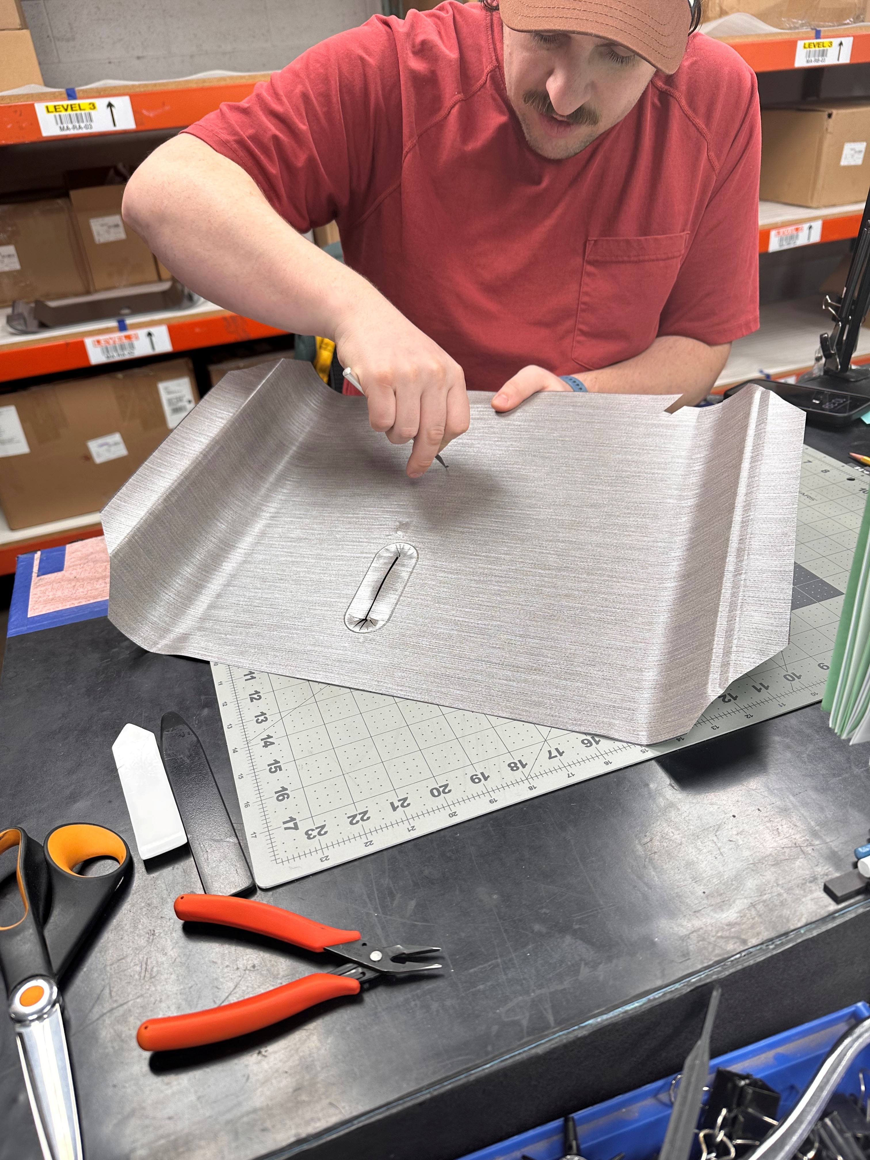 Technician assembling thermoformed parts on a workbench