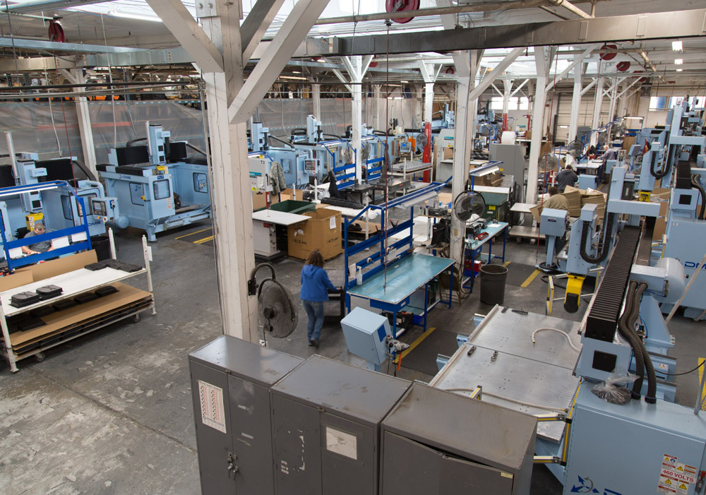 Row of CNC routers used to trim thermoformed parts