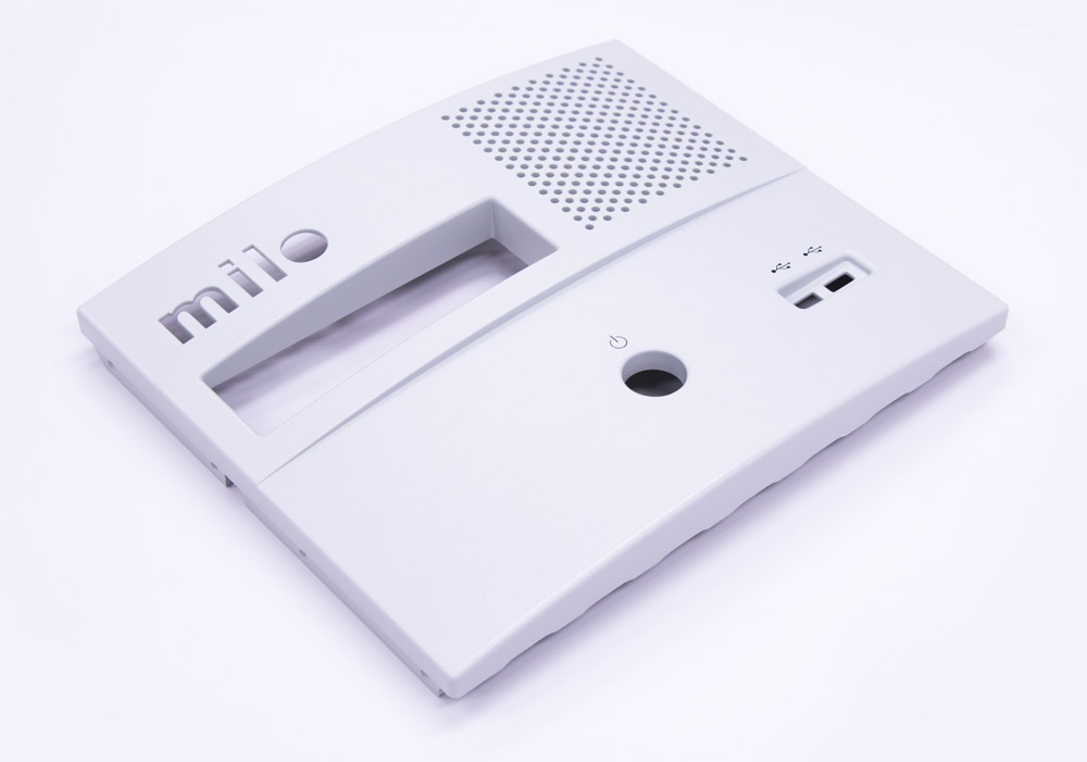 Thermoformed front cover with speaker grille and control cutouts