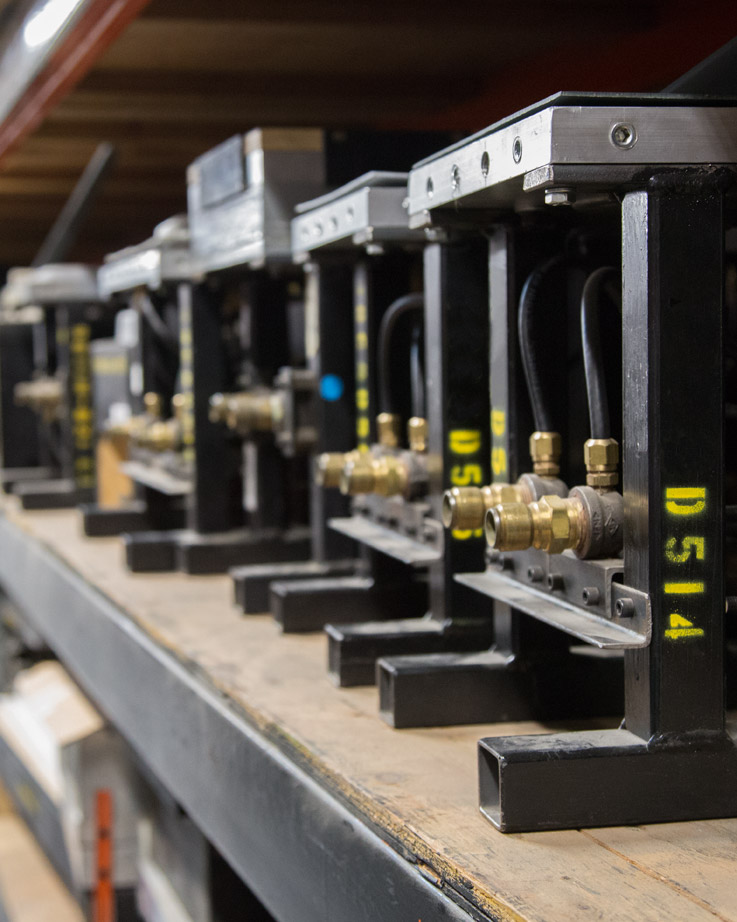 Shelves of labeled tooling and fixtures in storage
